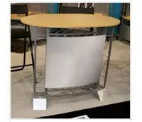 Oval countertop with a light wood finish on a metal frame with a white fabric panel - Iconic Displays