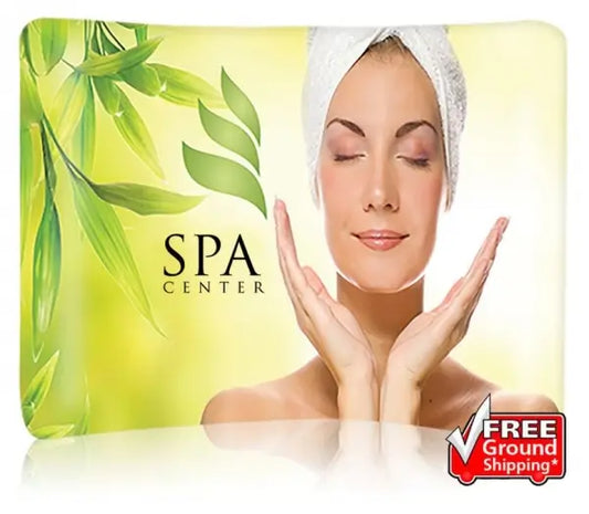 A curved fabric display featuring a woman with a towel on her head, green leaf graphics, and the "SPA CENTER" logo, with a "Free Ground Shipping" badge in the c