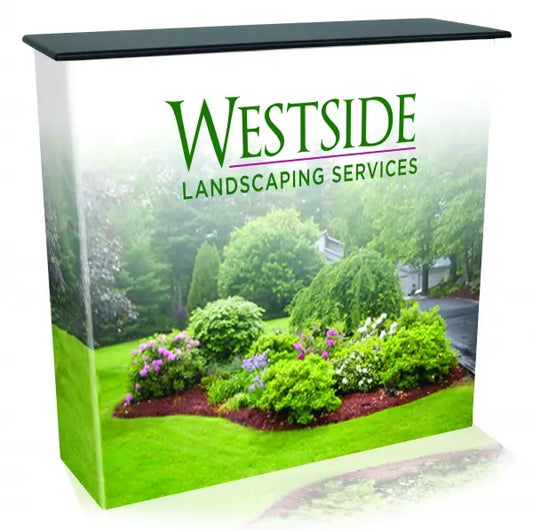 A portable display counter with a graphic featuring a lush garden scene and the "Westside Landscaping Services" logo. - Iconic Displays